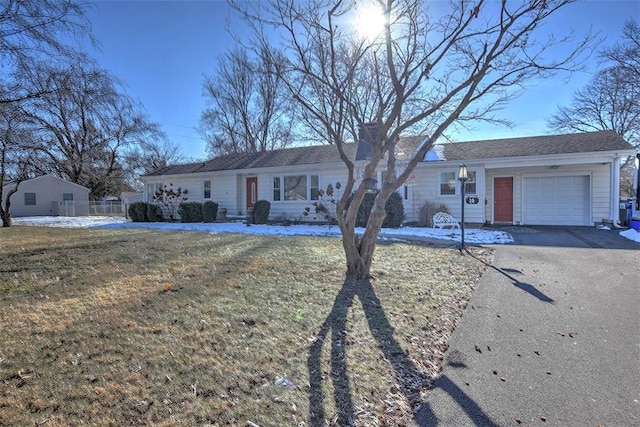 ranch-style home with a garage and a front yard