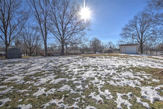 yard layered in snow with a garage