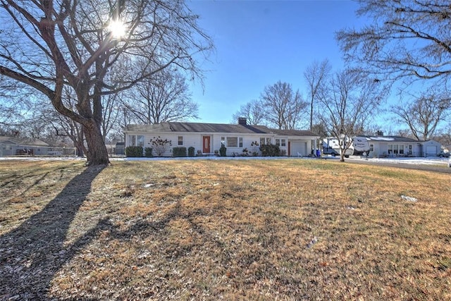 ranch-style house featuring a garage and a front yard