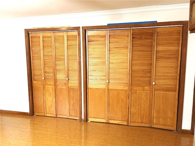 interior details with wood finished floors, baseboards, and ornamental molding
