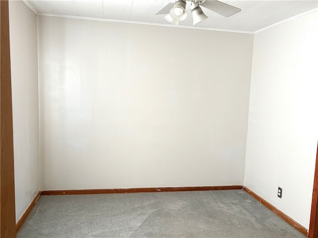 empty room featuring light colored carpet, baseboards, a ceiling fan, and crown molding