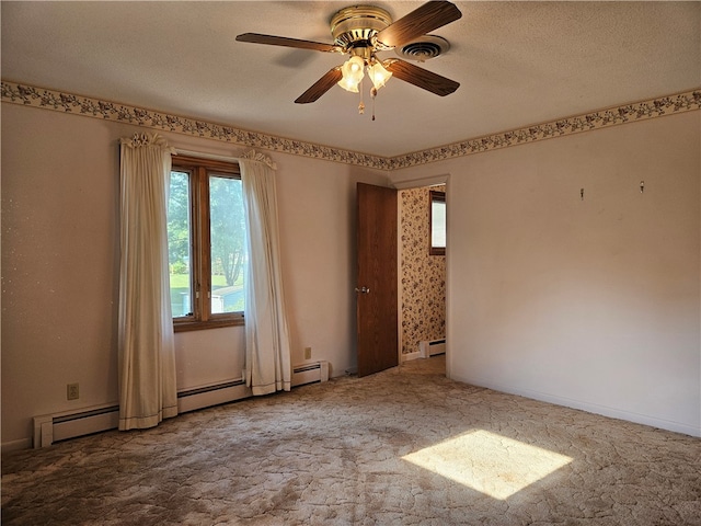 unfurnished room with carpet, ceiling fan, and a textured ceiling