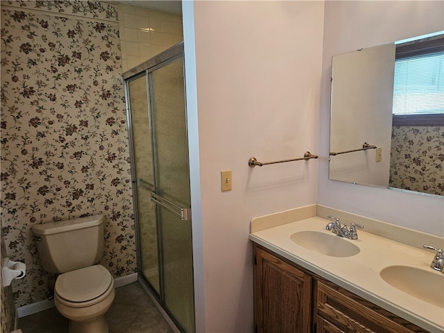 bathroom with vanity, toilet, and an enclosed shower