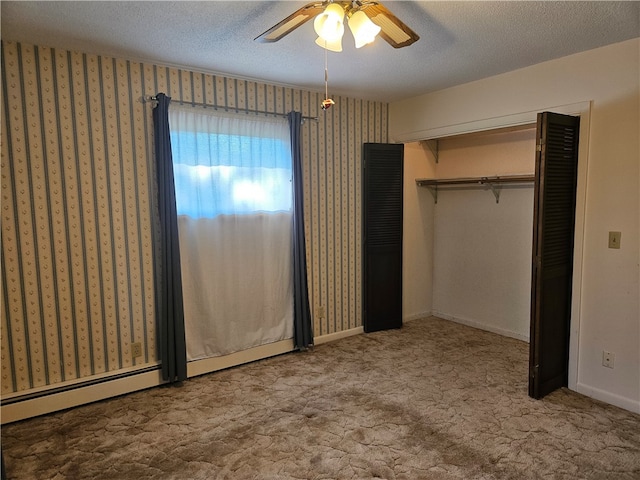 unfurnished bedroom featuring ceiling fan, a closet, light carpet, and a textured ceiling