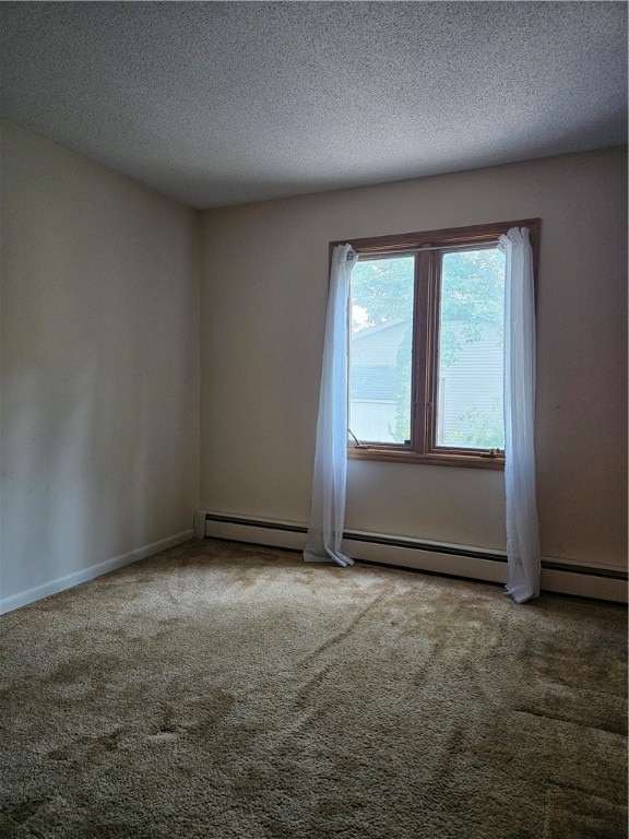 empty room with carpet, a textured ceiling, and a baseboard heating unit