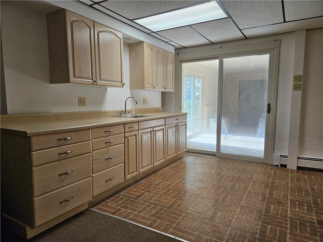 kitchen with light brown cabinets, sink, and a baseboard radiator