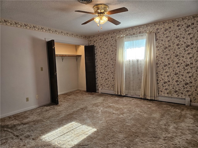 unfurnished bedroom with carpet flooring, a textured ceiling, a closet, and ceiling fan