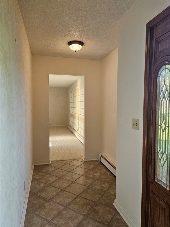 interior space with a baseboard radiator, a textured ceiling, and dark colored carpet