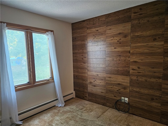 unfurnished room with light carpet, a textured ceiling, a wealth of natural light, and wooden walls