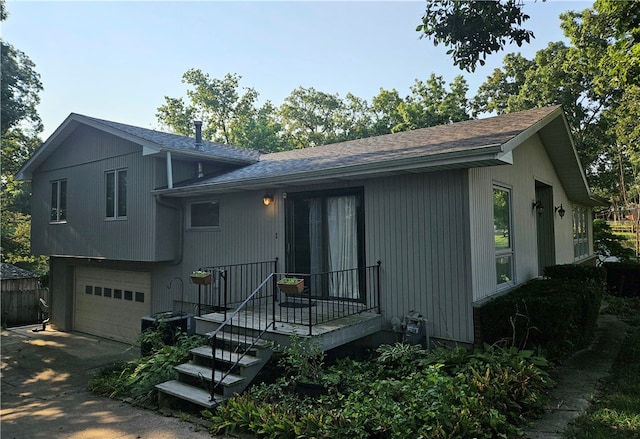 rear view of property featuring a garage