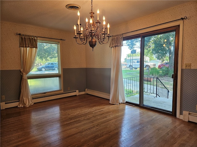 unfurnished dining area with a wealth of natural light, hardwood / wood-style floors, and a chandelier