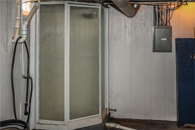 bathroom with electric panel and a stall shower