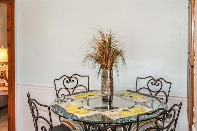 dining room with a wainscoted wall