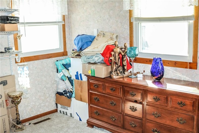 interior space featuring wallpapered walls, baseboards, and visible vents