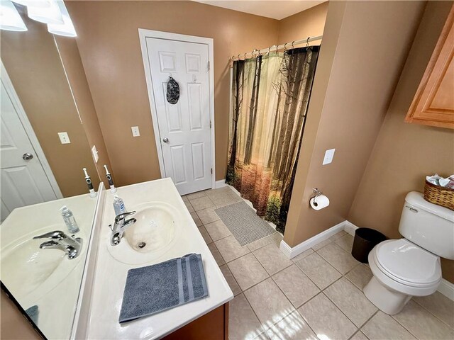 full bathroom with vanity, baseboards, curtained shower, tile patterned floors, and toilet
