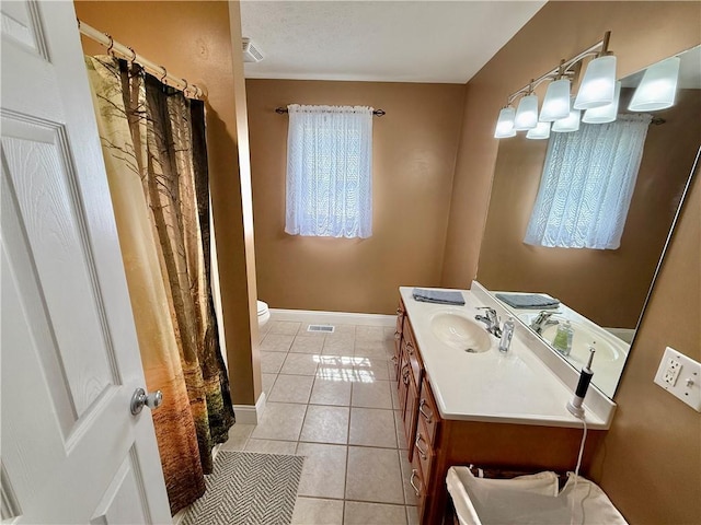 bathroom featuring visible vents, curtained shower, toilet, vanity, and tile patterned floors