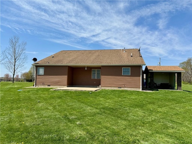 back of property with a patio area, crawl space, and a lawn