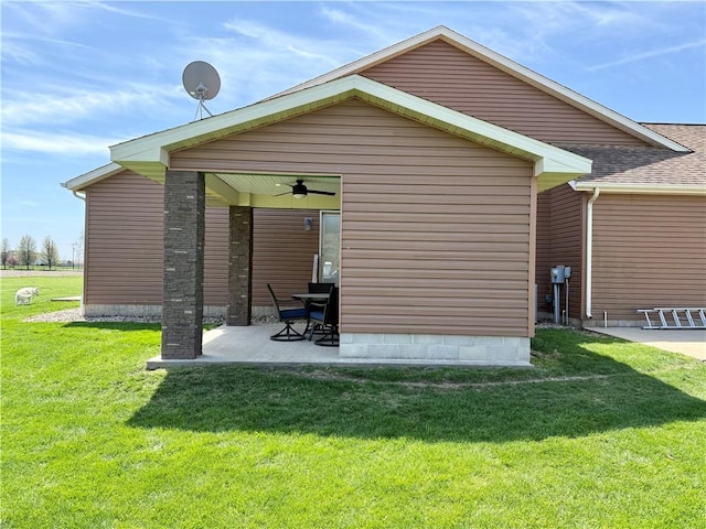 back of house featuring a patio, a yard, and ceiling fan