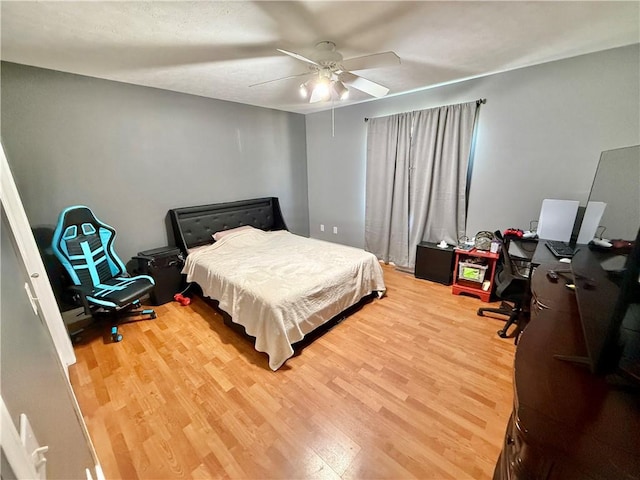 bedroom with a ceiling fan and wood finished floors