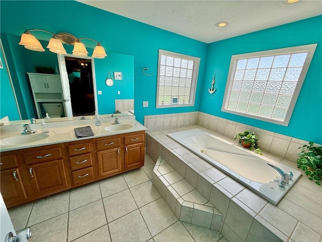 full bathroom with a bath, tile patterned floors, a sink, and double vanity