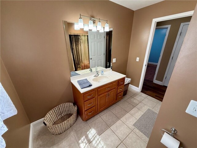 bathroom featuring baseboards, a shower with curtain, a chandelier, vanity, and tile patterned floors