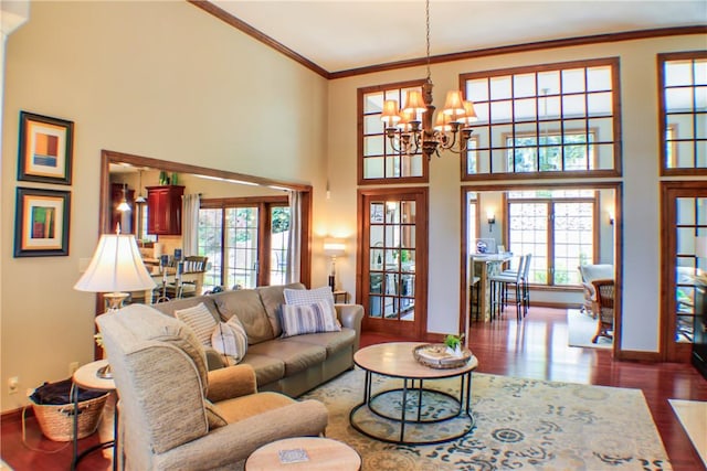 6086 Chicory Knl, Charleston, IL 61920 - living area with a chandelier, healthy amount of natural light, dark wood-type flooring, a high ceiling, and crown molding