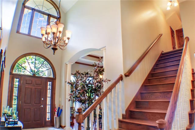 6086 Chicory Knl, Charleston, IL 61920 - entryway with a towering ceiling, arched walkways, stairway, a chandelier, and decorative columns