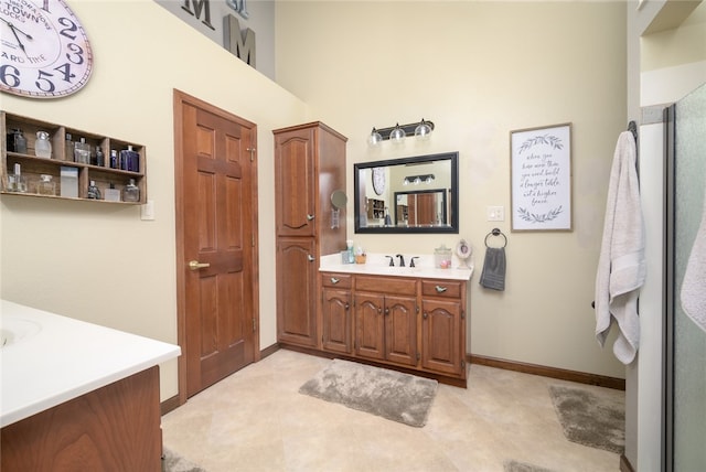 bathroom featuring vanity and a towering ceiling