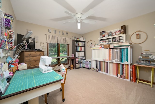 carpeted office space with ceiling fan