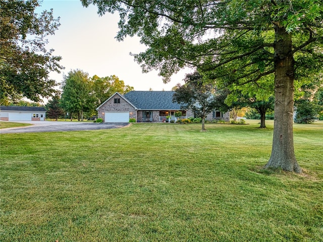 ranch-style house with a garage and a front yard