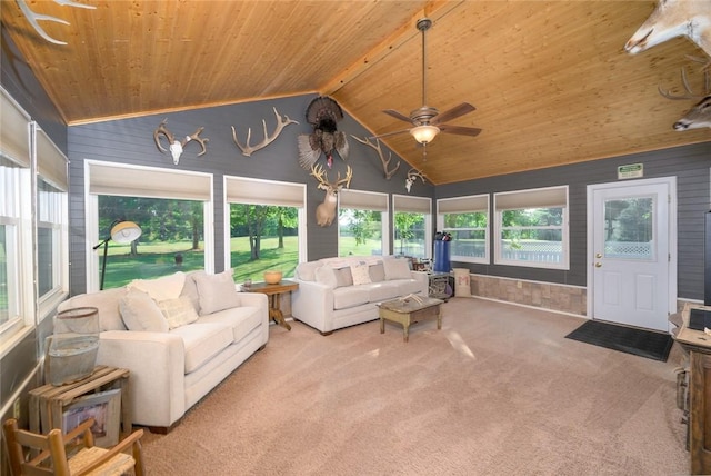 sunroom with vaulted ceiling with beams, a wealth of natural light, ceiling fan, and wood ceiling