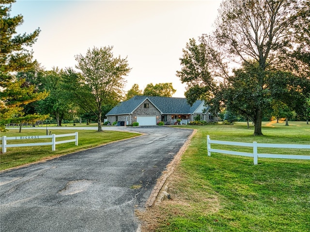 view of front of house featuring a front yard and a garage