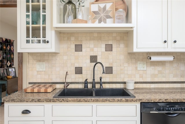 kitchen with backsplash, white cabinetry, dishwasher, and sink