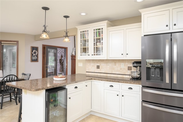 kitchen featuring white cabinetry, stainless steel fridge with ice dispenser, hanging light fixtures, and wine cooler