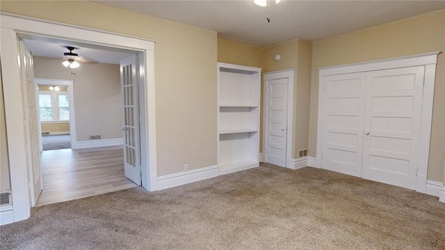 unfurnished bedroom with light colored carpet