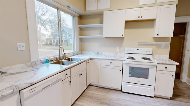 kitchen featuring light wood-type flooring, white appliances, white cabinets, and sink