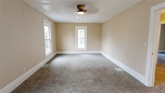 spare room featuring carpet floors and ceiling fan