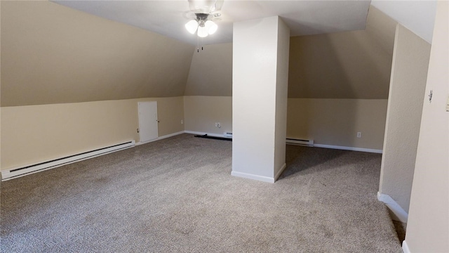 additional living space featuring light carpet, lofted ceiling, and a baseboard heating unit