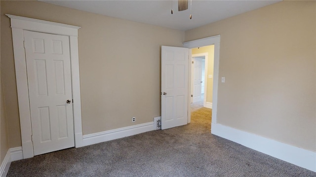 carpeted empty room with ceiling fan