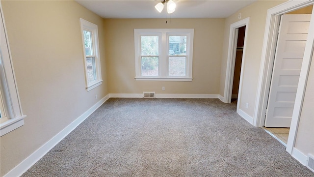 unfurnished bedroom featuring ceiling fan and light colored carpet