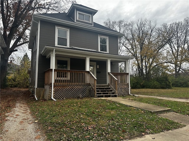 view of front of house with covered porch and a front yard