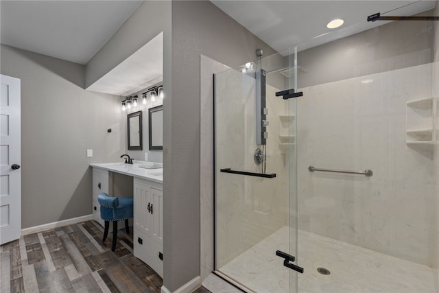 bathroom featuring a shower with door, wood-type flooring, and vanity