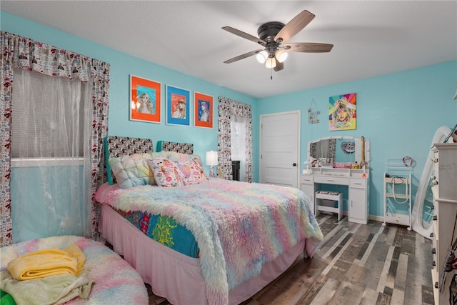 bedroom with ceiling fan and dark hardwood / wood-style floors