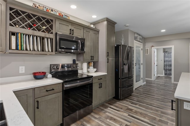 kitchen featuring dark wood-type flooring and appliances with stainless steel finishes