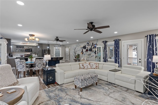 living room featuring light wood-type flooring and ceiling fan