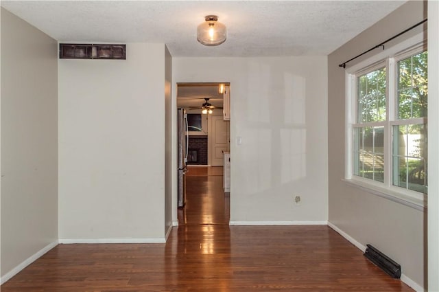 317 Hickory Ln, Mattoon, IL 61938 - empty room featuring wood finished floors, ceiling fan, and a textured ceiling