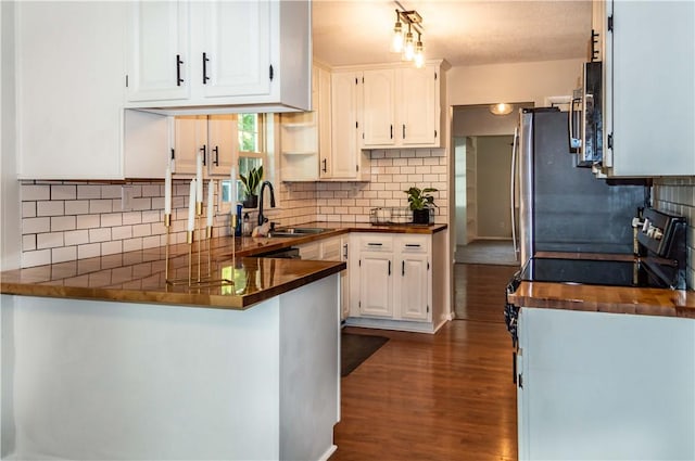 317 Hickory Ln, Mattoon, IL 61938 - kitchen featuring a peninsula, dark wood finished floors, range with electric cooktop, and tasteful backsplash