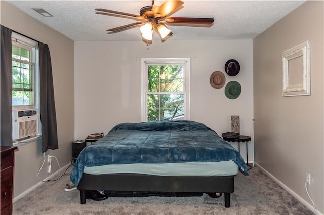 317 Hickory Ln, Mattoon, IL 61938 - carpeted bedroom featuring multiple windows, a textured ceiling, cooling unit, and ceiling fan