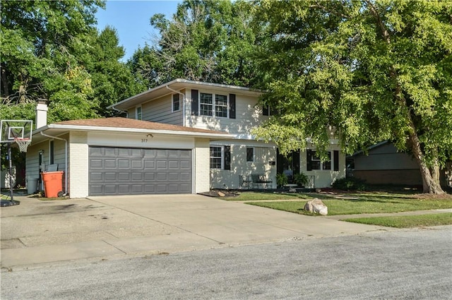 317 Hickory Ln, Mattoon, IL 61938 - traditional-style home with concrete driveway, brick siding, an attached garage, and a front lawn