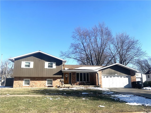 split level home featuring a garage and a front yard